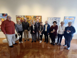 Seniors taking a photo at an art gallery
