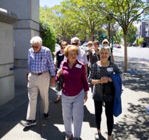 A group of seniors walking down the street in downtown Walnut Creek