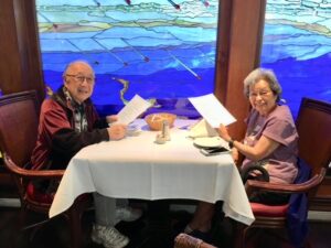 Senior smiling sitting at a dinner table